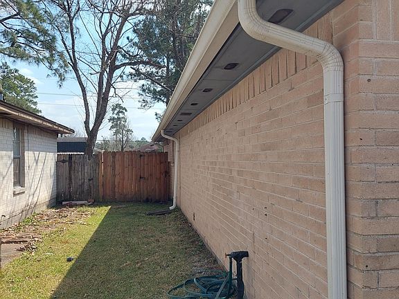Side yard leads to back gate. A hose & sprinkler are included with the home.