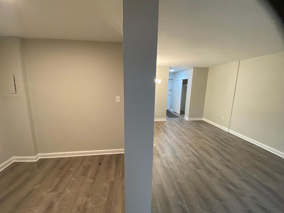 Bed area on left, living area on right, no door between, just an opening