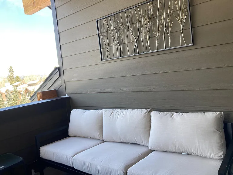 Full Size Couch on Third Floor Deck Next to Hot Tub