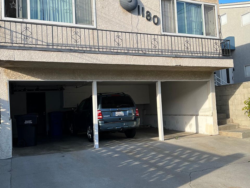 Secured shared laundry room located in this carport under the font of the bridling. 1 unit of the Storage cupboard is also provided (the white cupboards in photo in front of car)