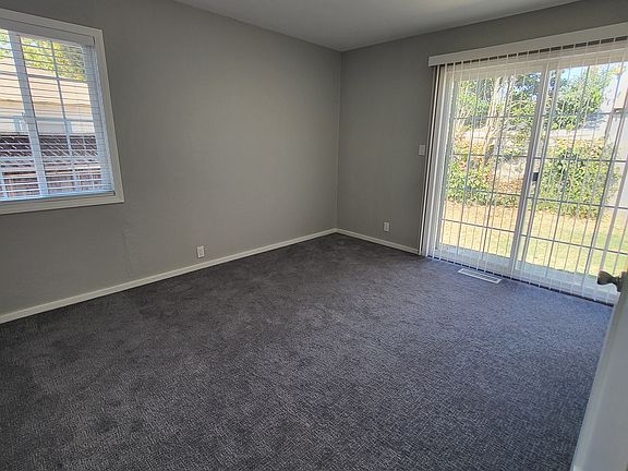 Bedroom #1 with new paint, blinds, carpeting, and lighting.