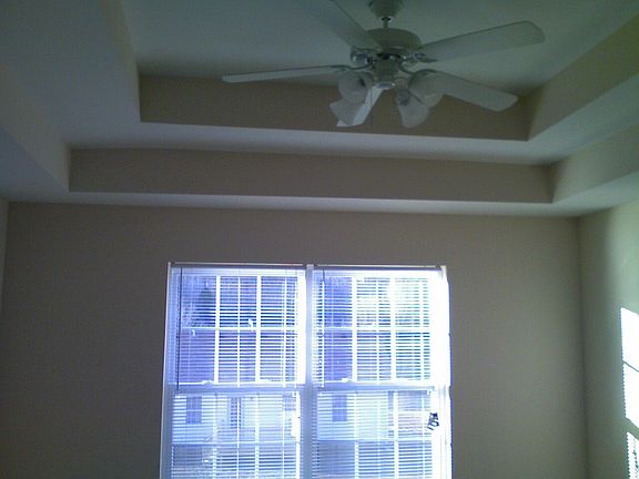 Double trey ceiling in Master Bedroom with Ceiling Fan.