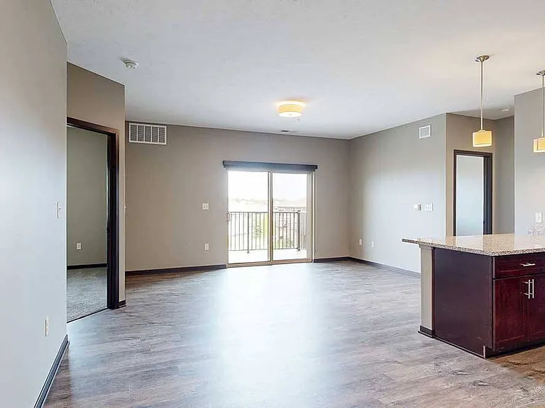 Relax or host in a bright, open-concept living space with seamless flow to the kitchen and balcony.