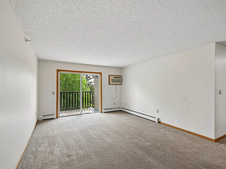 Step into the spacious living area of Mill Pond Apartments, where natural light fills the room and a private balcony awaits. Ideal for relaxation and creativity, this apartment offers a blank canvas for your personal touch. Schedule a tour today!