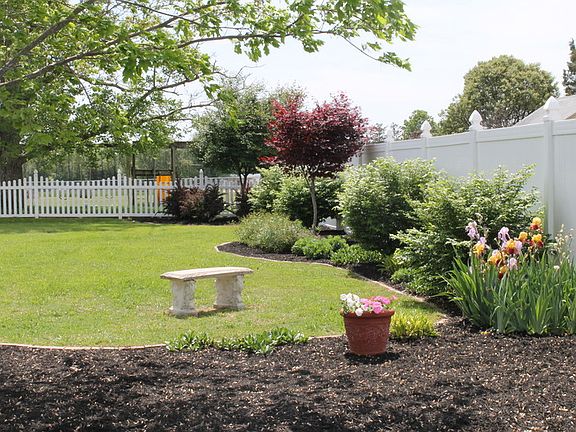Front yard
						:
						Picture of front yard in the spring time. Custom landscaping.