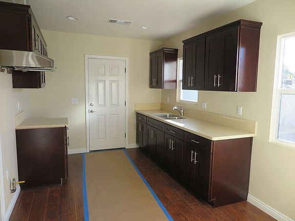 Kitchen with back door. Kitchen stovetop/oven are installed 