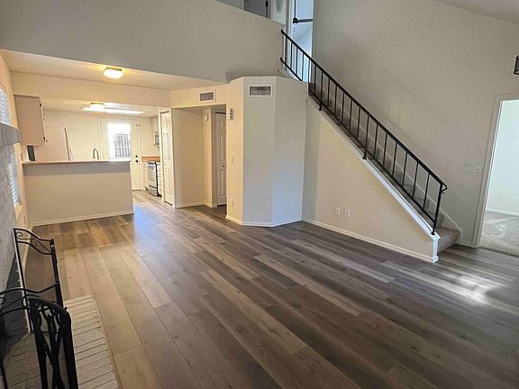 View of living room looking into kitchen & upstairs loft