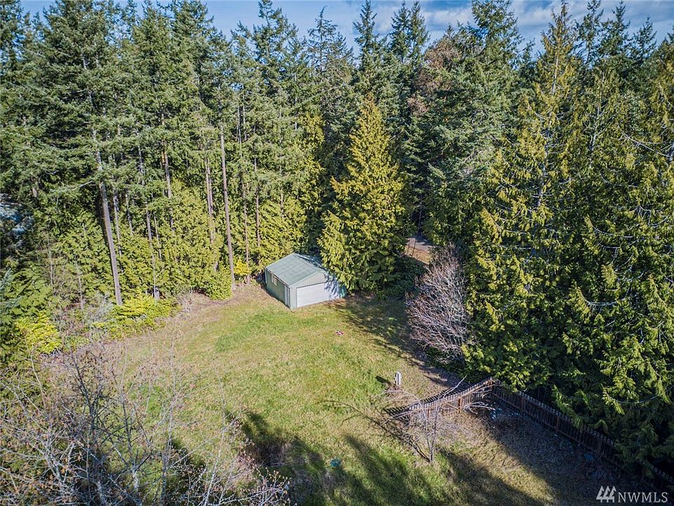 Trees surround the exterior with a cleared area in the center. 400 sq foot garage just off Magnolia.