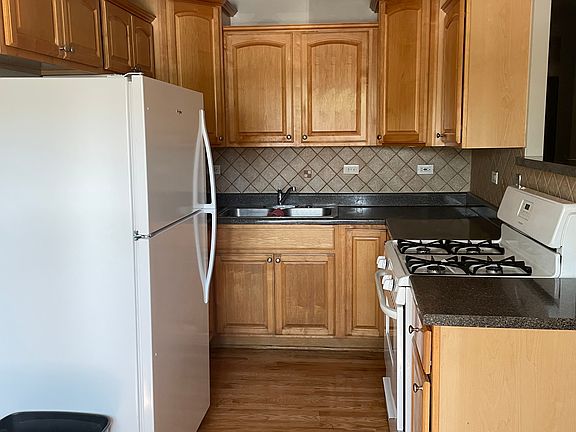 Kitchen with brand new refrigerator, microwave and stove.