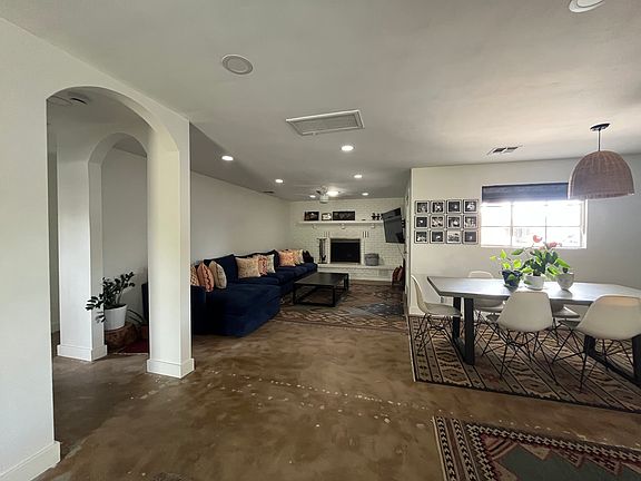 Open concept- kitchen + living room + dining room. Arched hallways lead to bedrooms and bathrooms.
