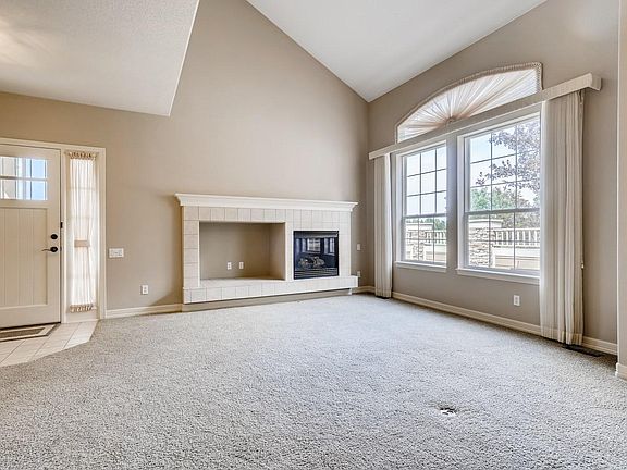 Elegant and cozy fireplace and TV area. The high cathedral ceilings give an open feeling. The window looks out to the private side patio.