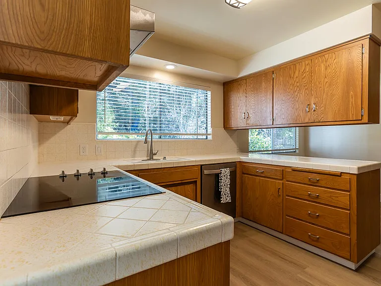 Kitchen with new stove top and dishwasher