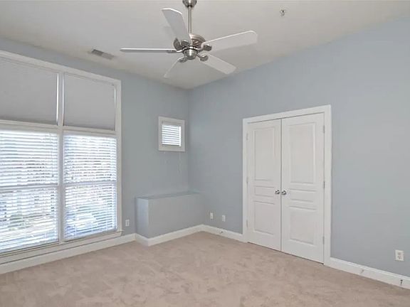 Primary bedroom with beautiful tall ceilings, excellent natural light, and large walk in closet