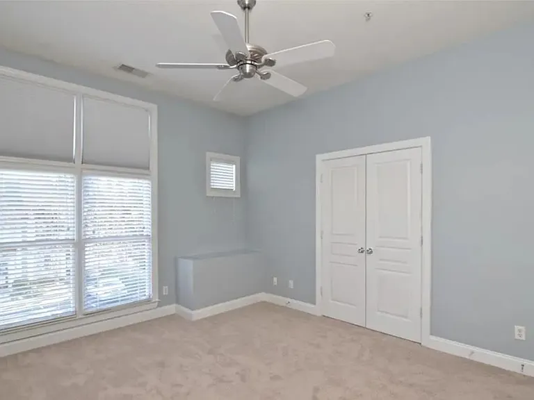 Primary bedroom with beautiful tall ceilings, excellent natural light, and large walk in closet