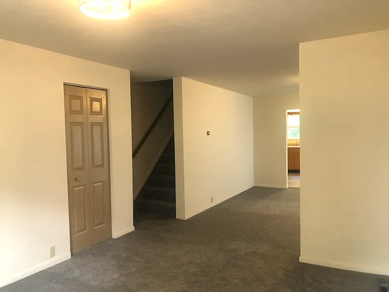 Dining room / living room leading to upstairs.
