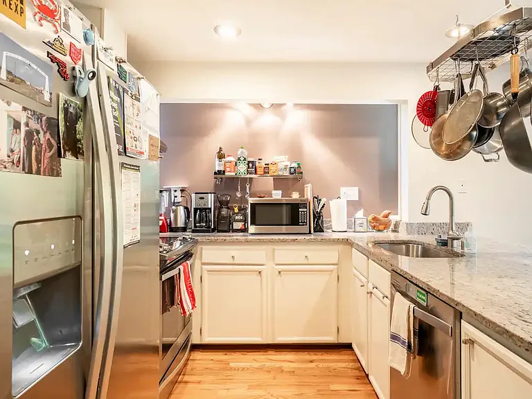 Full kitchen with dishwasher, oven, microwave, toaster oven, fridge, and pots & pans.