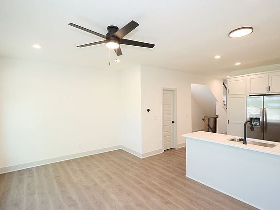 Looking from the living room towards the kitchen and half bath.