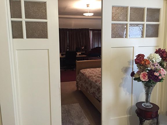 Pocket doors divide living room from bedroom.