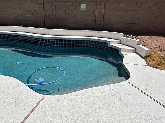 Pebble tech pool with waterfall.