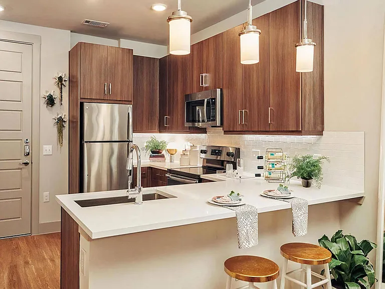 Island Kitchen with Sleek Dark Wood Cabinets and Undercabinet Lighting