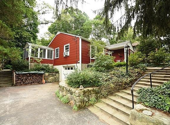 Large driveway with access to garage, front and back yards