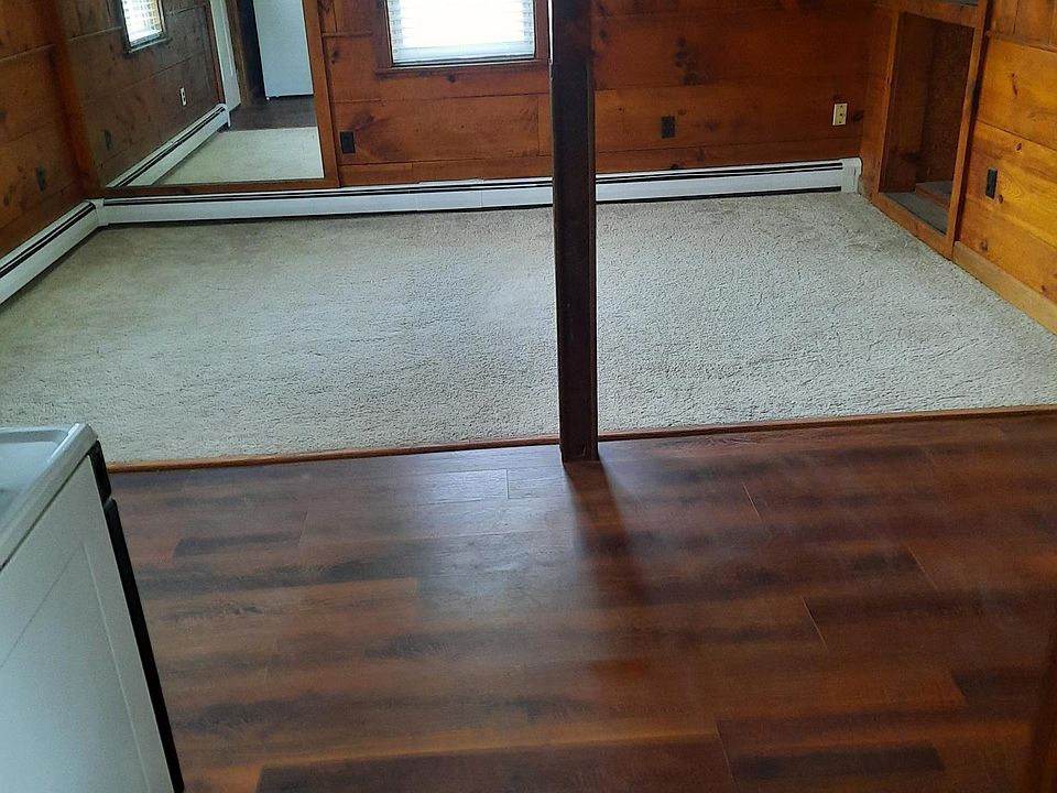 open living room/dining area with built in shelving and large built in mirror