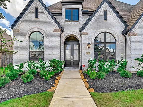 Nice landscaping and gabled roofing.