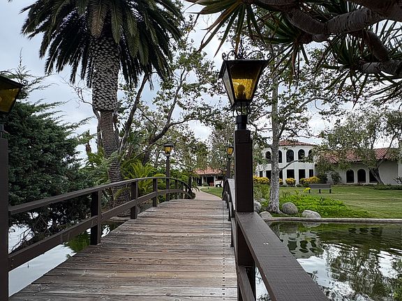 View from pool area over bridge to Ranch Carlsbad Clubhouse includes movie rentals, library, billiards room, commercial kitchen, entertainment and dance hall, bride/banquet room, copy center, movie night Livingroom for all.