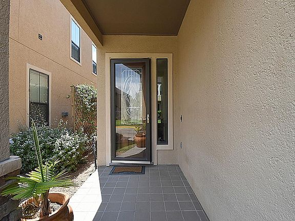 Tiled front porch leads to a leaded glass front door with side light to welcome you to your new home!