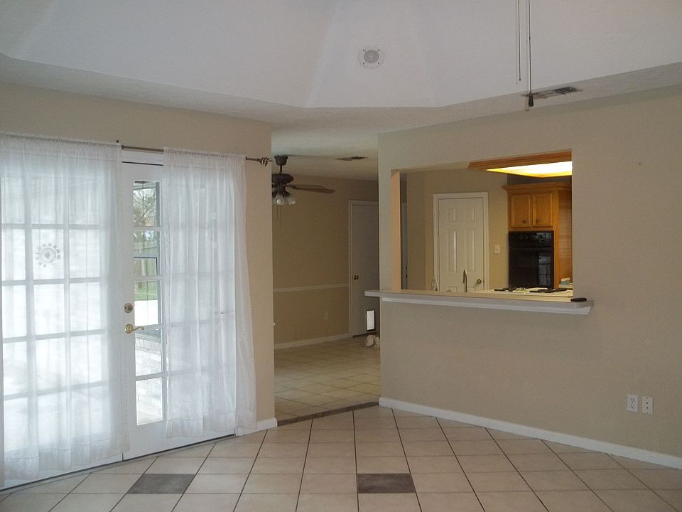 View of kitchen & french doors that lead to the back yard, patio and pool.