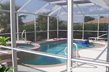 View of Pool/Hot tub w/birdcage enclosure.