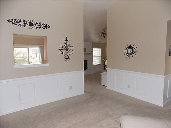 View of pass-through to kitchen.  Wainscoting and chair rail.  All rooms freshly painted within the last two years.