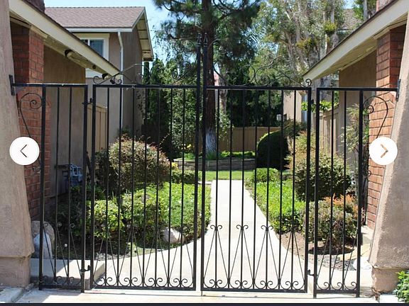 Courtyard entrance from the front yards. Access also available from the side driveway and private parking garages