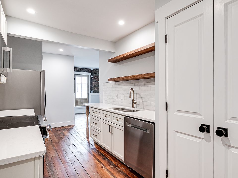 Enter the apartment into the galley kitchen. The large pantry is to the right of the dishwasher seen in this view.