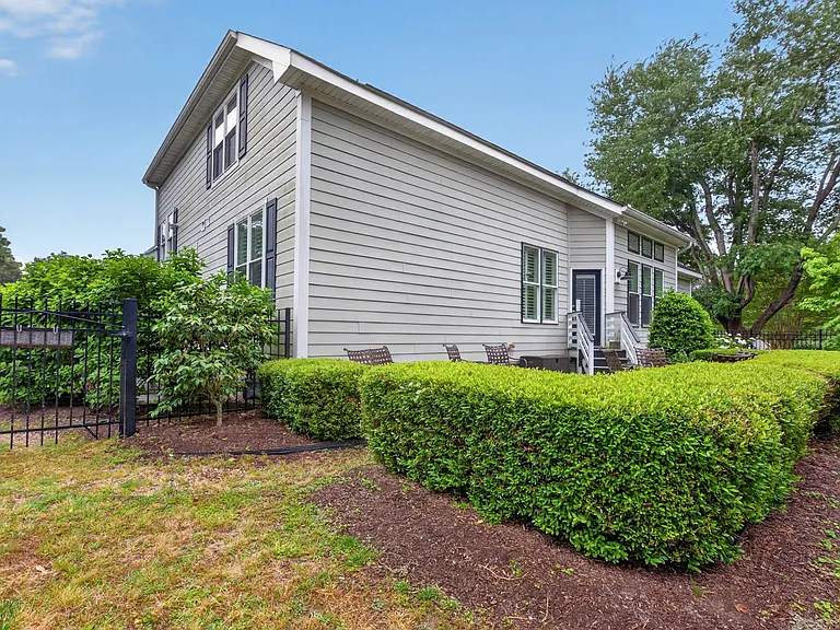 Manicured landscaping, fenced in backyard and large concrete patio