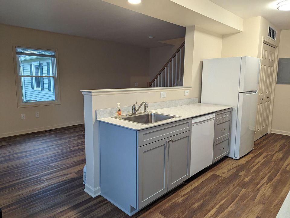 Another kitchen pic from eating counter looking into living room. Living room has one south facing window. All windows have mini-blinds.