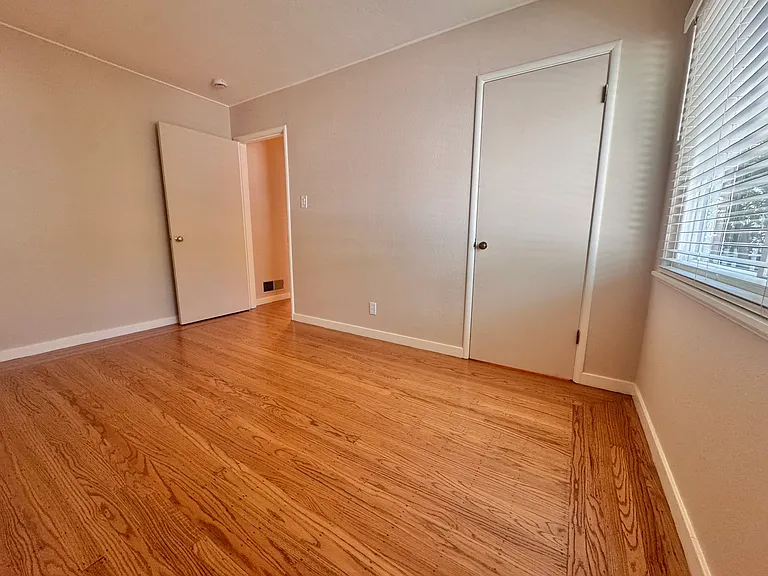 The third bedroom is the most private, quietly anchoring the northeast corner of the house. Both bedrooms feature deep, spacious closets.