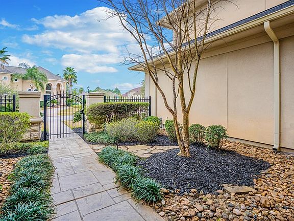 This view from the front porch shows off the courtyard in front of the home. The front and back sprinkler system makes maintaining the lush landscaping a snap!