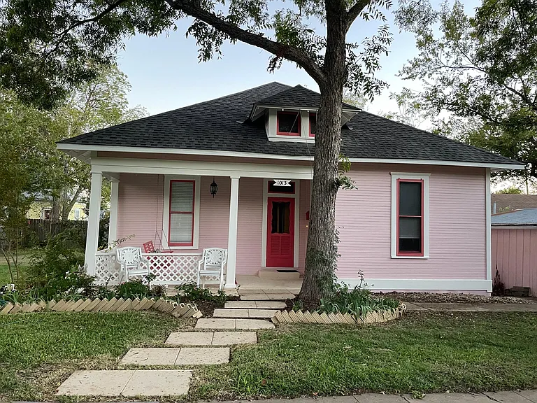 Front of house with steps to sidewalk.