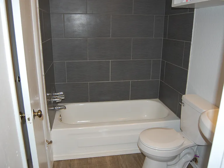 Beautiful charcoal ceramic tile tub enclosure.