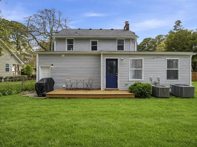 The huge backyard includes a deck and grill. Perfect for kids or pets that want to run around.