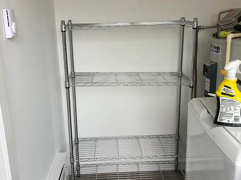 Laundry room with new washer and dryer, sliding glass door exit to backyard deck.