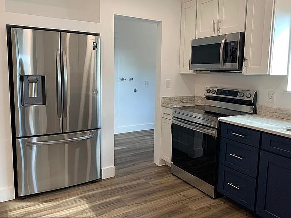 upstairs kitchen. There is now a laundry unit through the doorway.