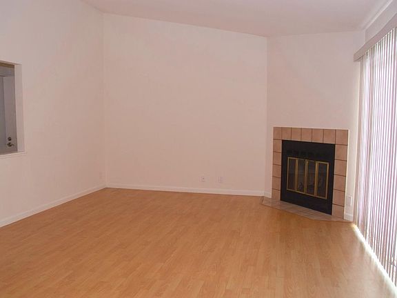 Living room with fireplace and balcony. Fresh new painting throughout the entire unit.