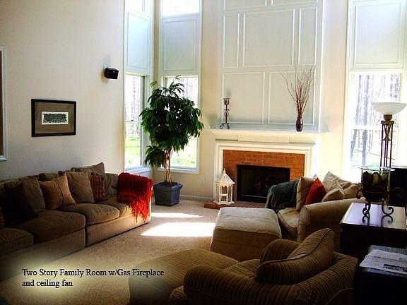 2 story family room with gas fireplace and ceiling fan