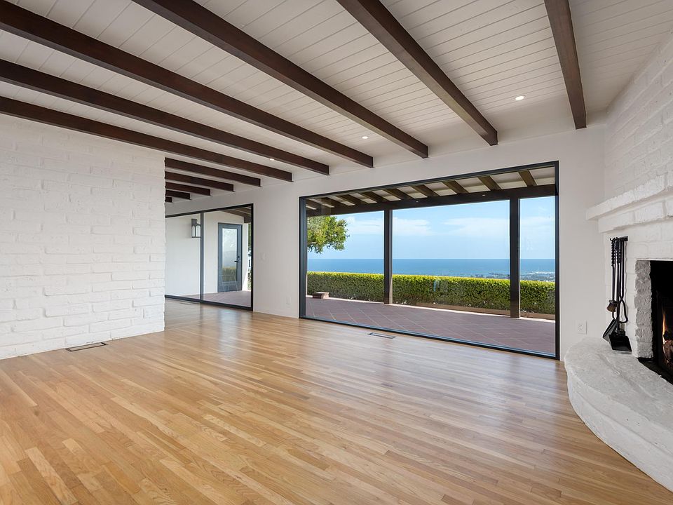 Sweeping views from this elevated hancienda with restored adobe walls enshrouding the living room, adding warmth, texture, and a timeless sense of place.