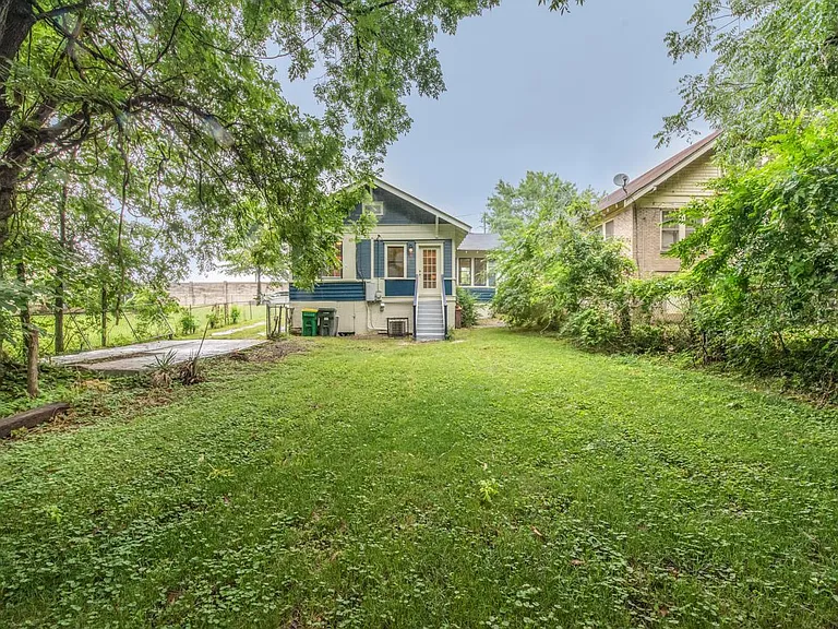 Deep back yard with parking pad