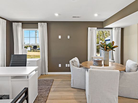 Bright dining and office space with natural light, perfect for work and meals.