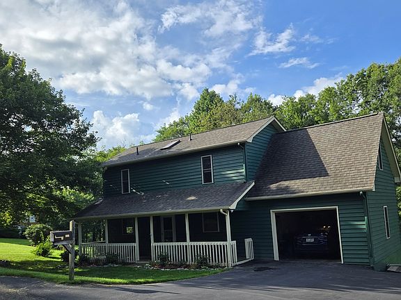 Large driveway can accommodate many cars. Half acre lot