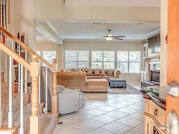 As you walk in, you are welcomed into a spacious open floor plan with a wall of windows that span th